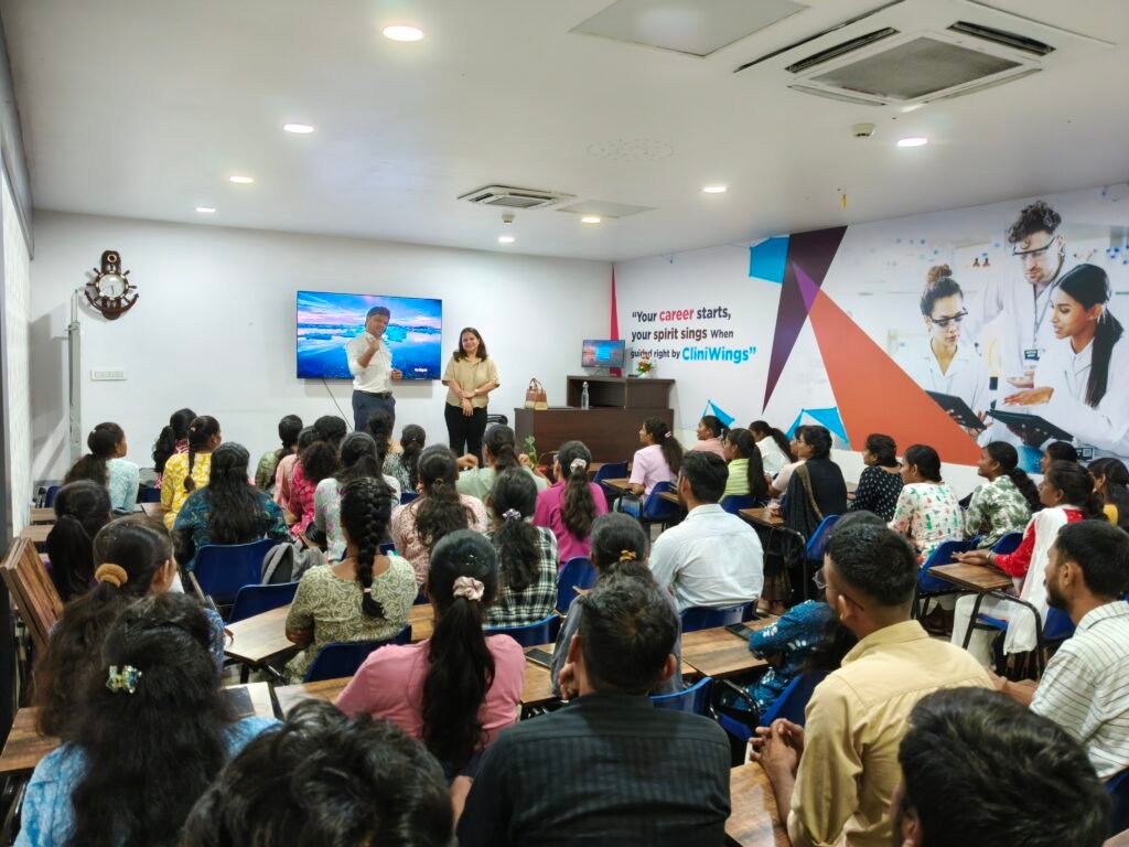 Indian pharmacy students in lab coats during CliniWings training