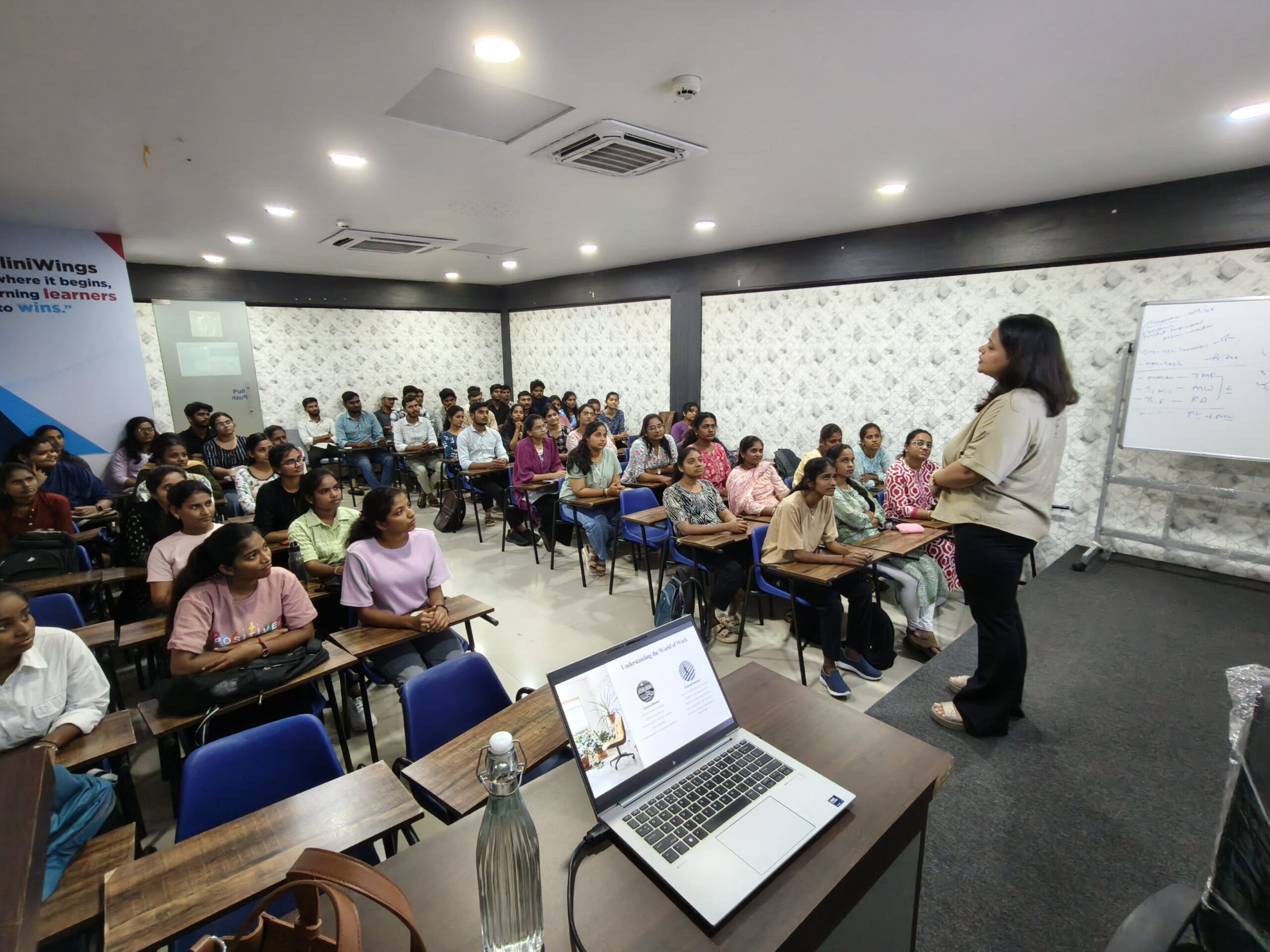 CliniWings medical students in lab coats during training session