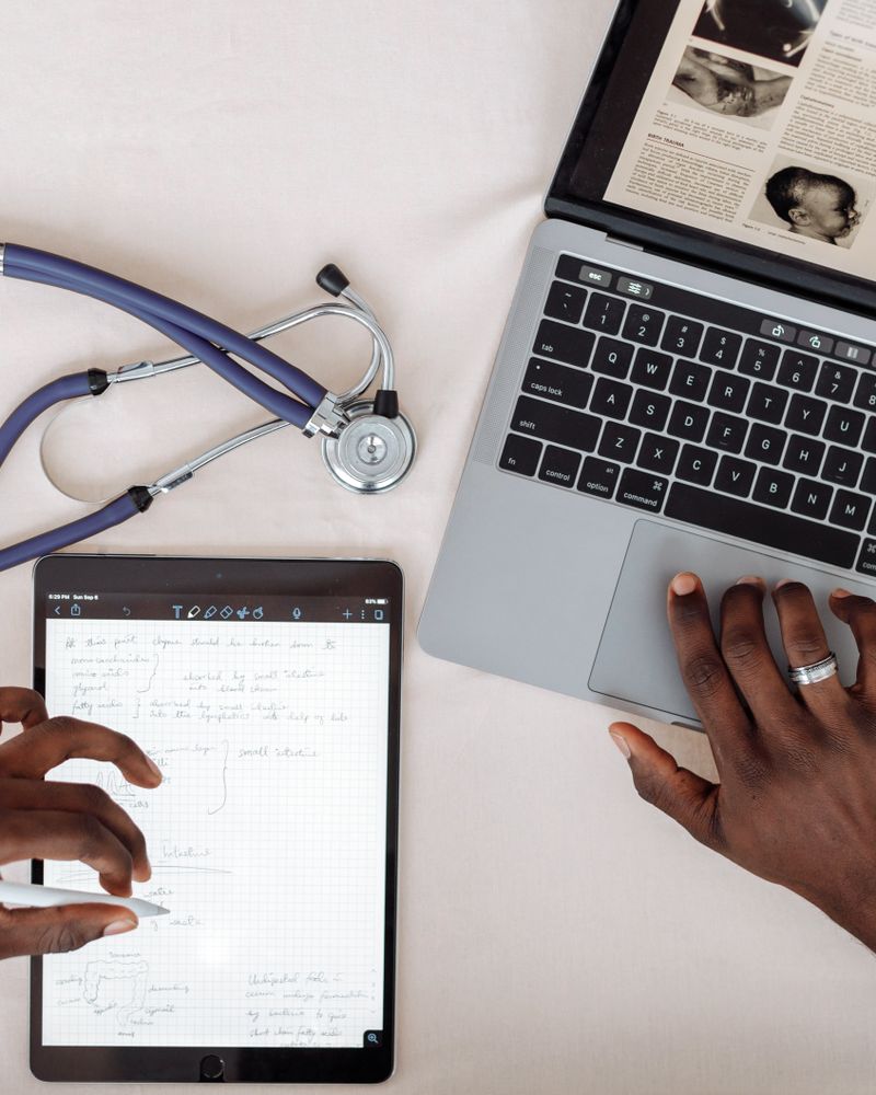 Real-world evidence: healthcare professional reviewing patient data on a tablet and laptop